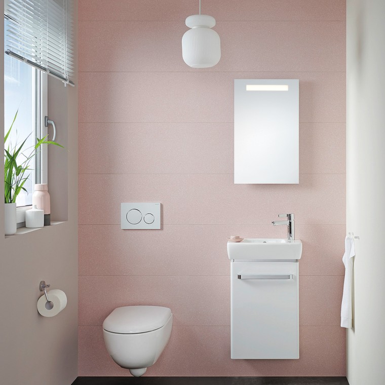 Liten gästtoalett med kompakt möbelskåp och vägghängd WC